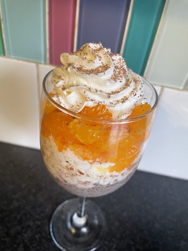 Chocolate orange chia seed pudding pot with mandarins & cream.
